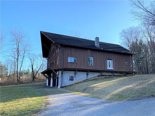 view of home's exterior with a yard and a chimney