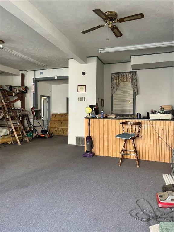 miscellaneous room with carpet floors and ceiling fan