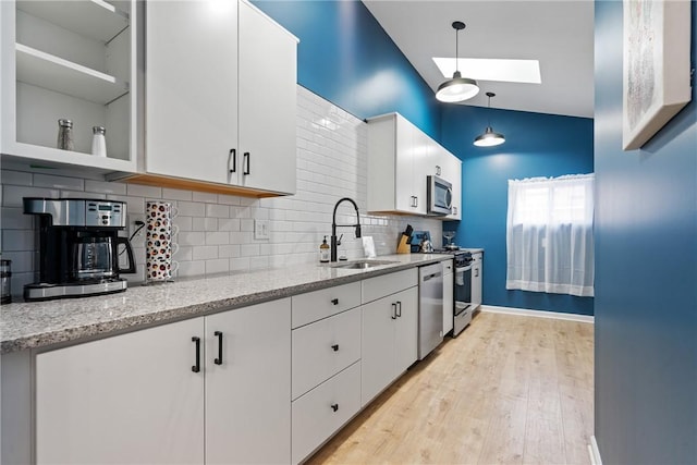 1015 Constance St, East Allegheny, PA 15212 - kitchen featuring a sink, a skylight, appliances with stainless steel finishes, and white cabinets