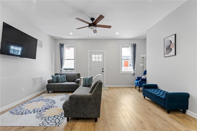 living area featuring visible vents, baseboards, ceiling fan, recessed lighting, and light wood finished floors
