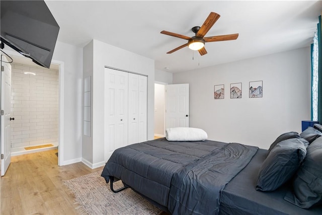 bedroom with a ceiling fan, light wood-type flooring, baseboards, a closet, and connected bathroom