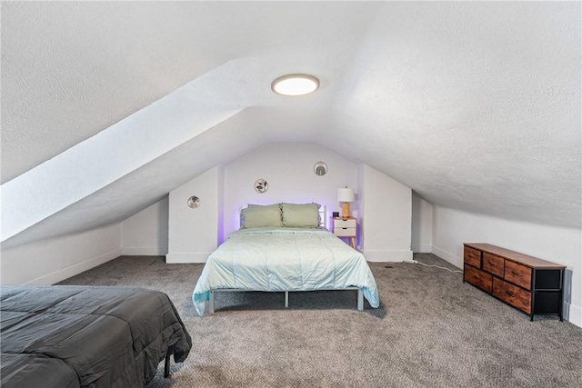 bedroom featuring carpet flooring, a textured ceiling, baseboards, and lofted ceiling