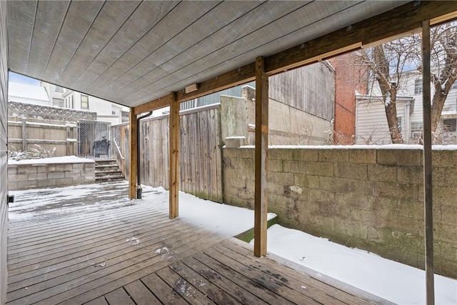 snow covered deck with fence