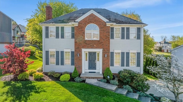 4012 Forest Dr, Hopewell Twp Bea, PA 15001 - colonial home with a chimney, a front lawn, and brick siding