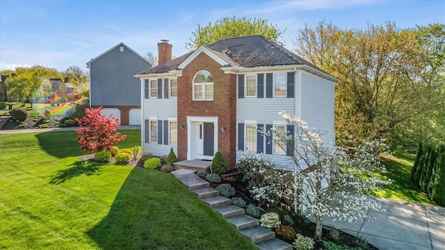 4012 Forest Dr, Hopewell Twp Bea, PA 15001 - colonial home with an attached garage, brick siding, a front lawn, and a chimney