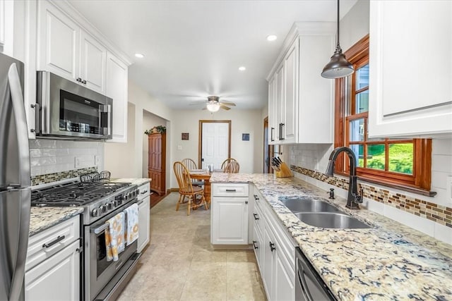 4012 Forest Dr, Hopewell Twp Bea, PA 15001 - kitchen featuring a sink, appliances with stainless steel finishes, decorative backsplash, and white cabinetry