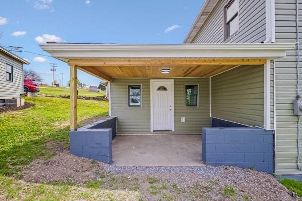 entrance to property with a lawn
