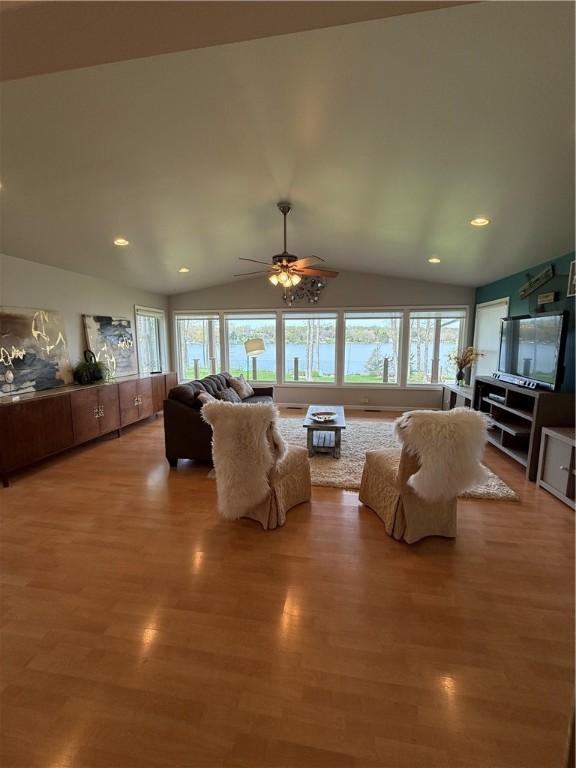 living room featuring recessed lighting, ceiling fan, lofted ceiling, and light wood-type flooring
