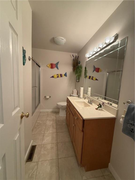 bathroom featuring visible vents, tile patterned flooring, vanity, toilet, and baseboards