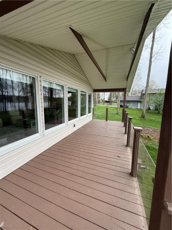 wooden terrace with a lawn