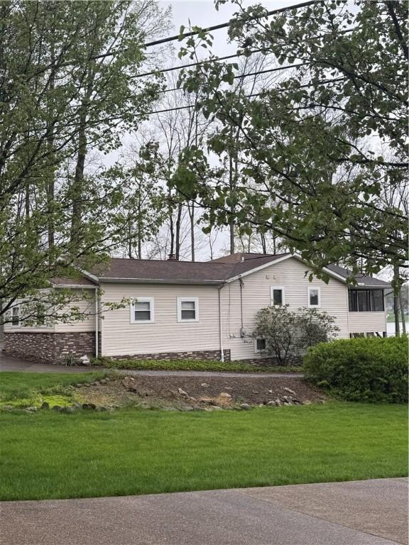 view of side of property featuring a yard and a chimney