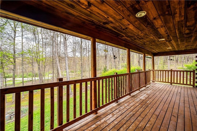 wooden deck with a forest view