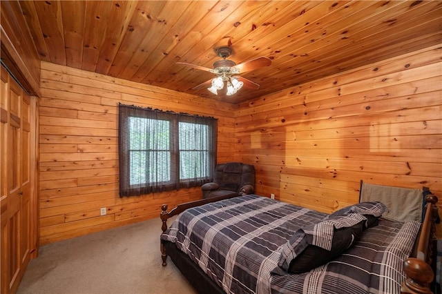 bedroom with wood ceiling, ceiling fan, carpet, and wood walls