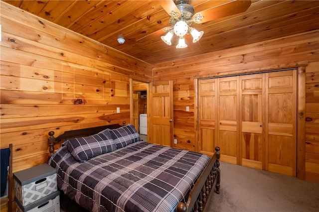 bedroom with wood ceiling, carpet, a ceiling fan, and wood walls
