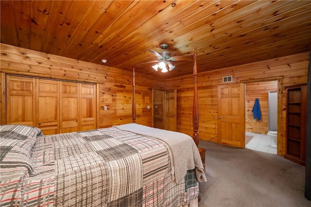 bedroom with wooden walls, carpet flooring, visible vents, and wood ceiling