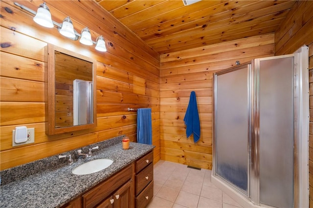 bathroom featuring vanity, tile patterned floors, wooden walls, and a shower stall