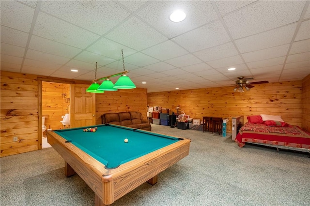 rec room featuring wooden walls, pool table, carpet, and a paneled ceiling