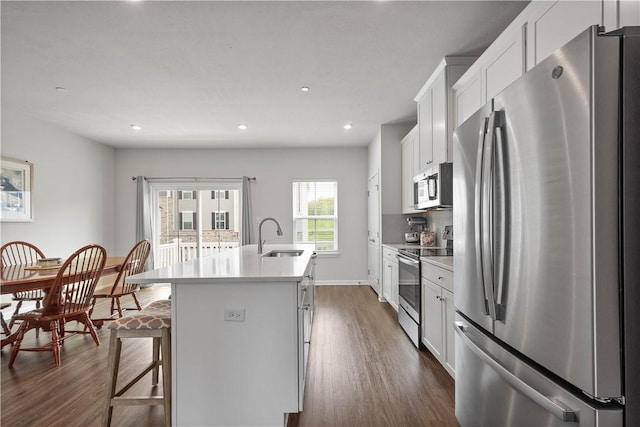 4404 Spruce Rd, Pine Twp Nal, PA 15044 - kitchen featuring appliances with stainless steel finishes, dark wood finished floors, a sink, light countertops, and an island with sink