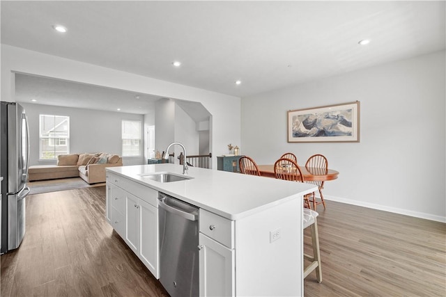 4404 Spruce Rd, Pine Twp Nal, PA 15044 - kitchen featuring white cabinets, a sink, a kitchen breakfast bar, an island with sink, and stainless steel appliances
