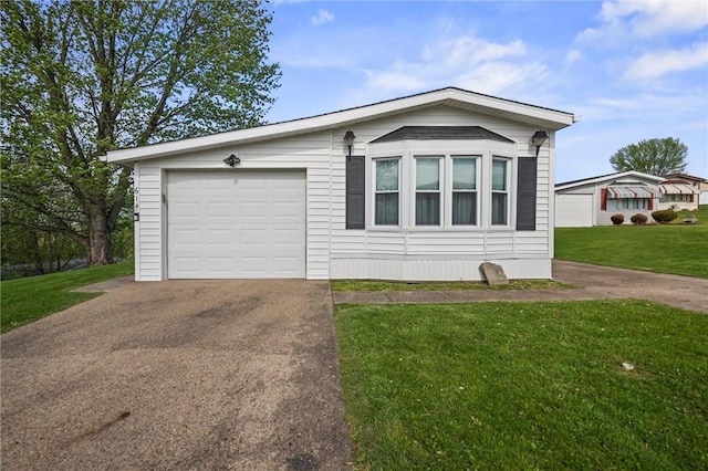 view of front of property featuring an attached garage, driveway, and a front lawn