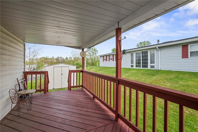 deck with an outbuilding, a yard, and a shed