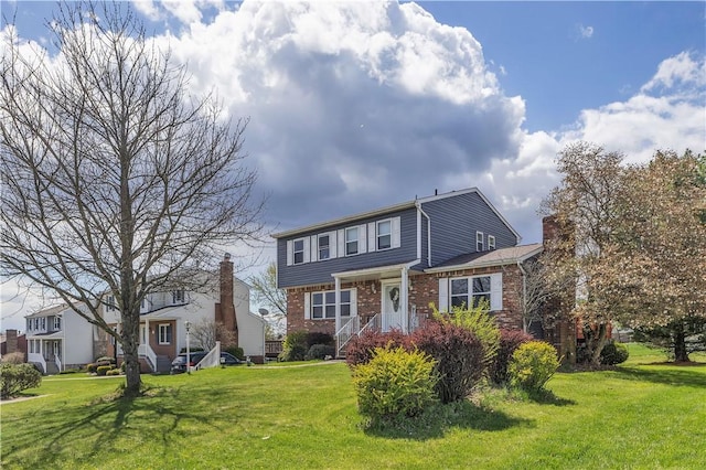 traditional-style home with brick siding, a front lawn, and a chimney