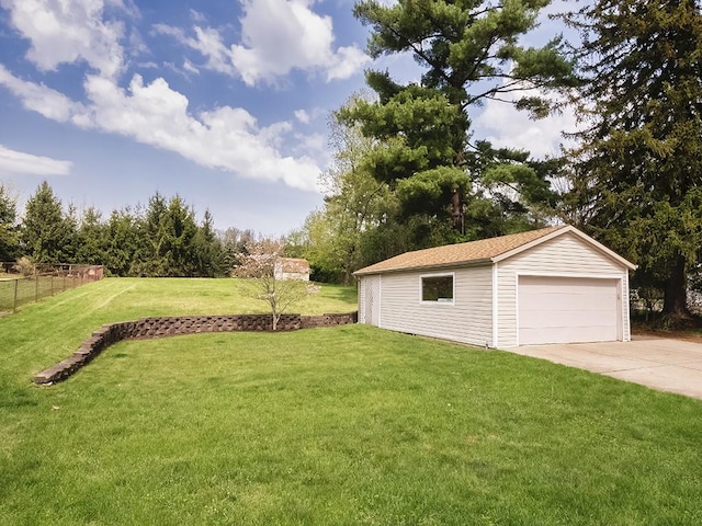 view of yard with fence, an outdoor structure, and a garage