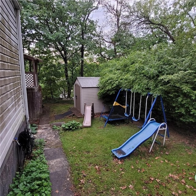 view of yard with an outbuilding, a playground, and a storage shed