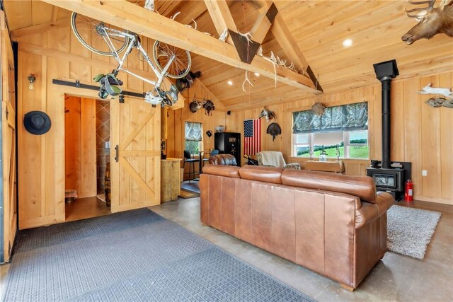6181 Brown Rd, Penn Twp, PA 16002 - living area featuring finished concrete floors, a wood stove, wooden ceiling, and wooden walls