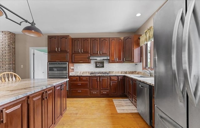 6181 Brown Rd, Penn Twp, PA 16002 - kitchen featuring appliances with stainless steel finishes, light wood-style floors, backsplash, and light stone counters