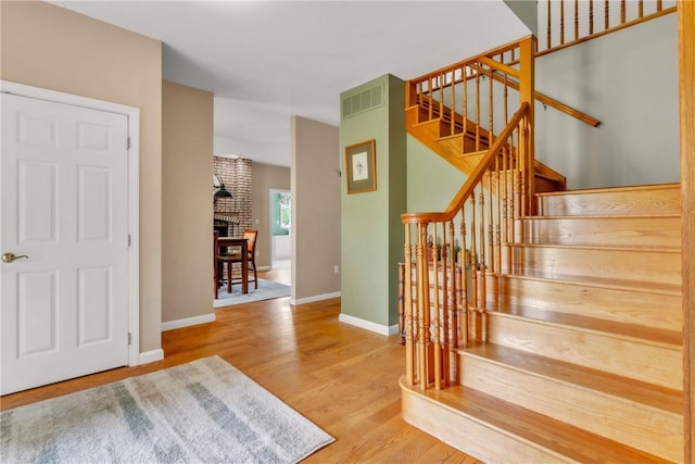6181 Brown Rd, Penn Twp, PA 16002 - stairs featuring wood finished floors and a brick fireplace