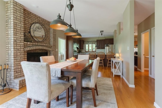 6181 Brown Rd, Penn Twp, PA 16002 - dining room with light wood-type flooring and a fireplace