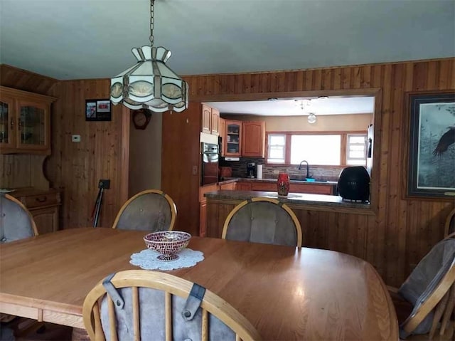 dining room with wood walls