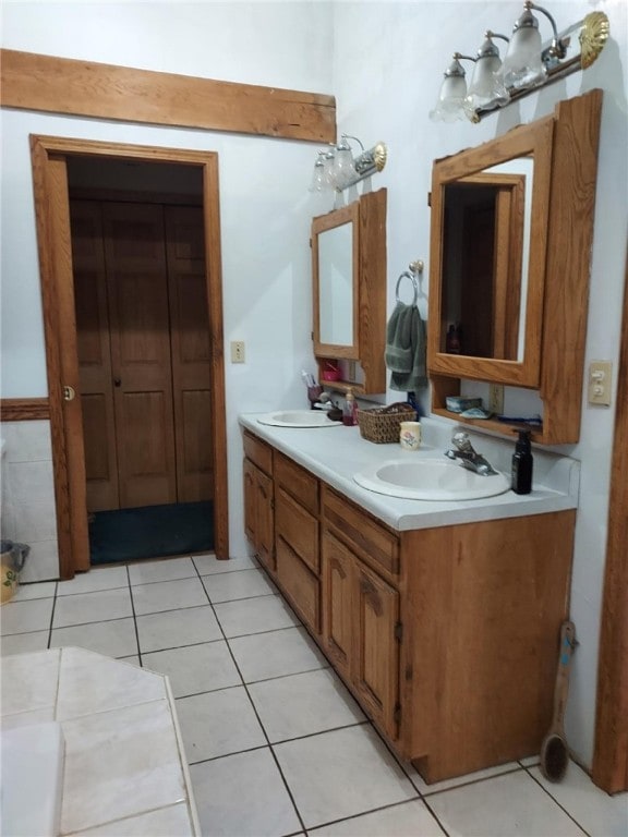bathroom featuring a sink, tile patterned flooring, and double vanity