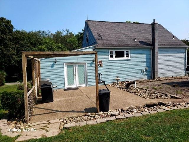 back of property with french doors and a patio area