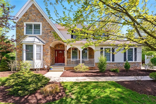 view of front of house with a porch and stone siding