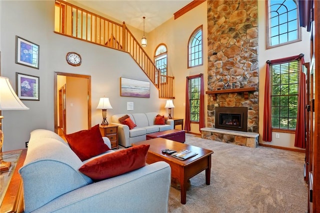 carpeted living area with baseboards, stairs, a high ceiling, and a wealth of natural light