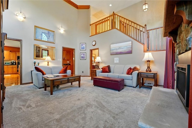 living area with stairway, a high ceiling, and carpet flooring