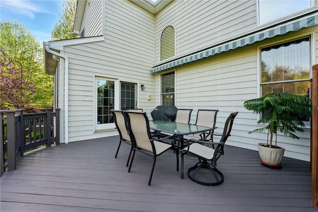 wooden deck featuring outdoor dining area