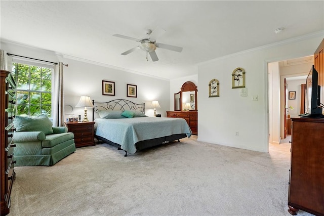 bedroom with a ceiling fan, light carpet, and ornamental molding