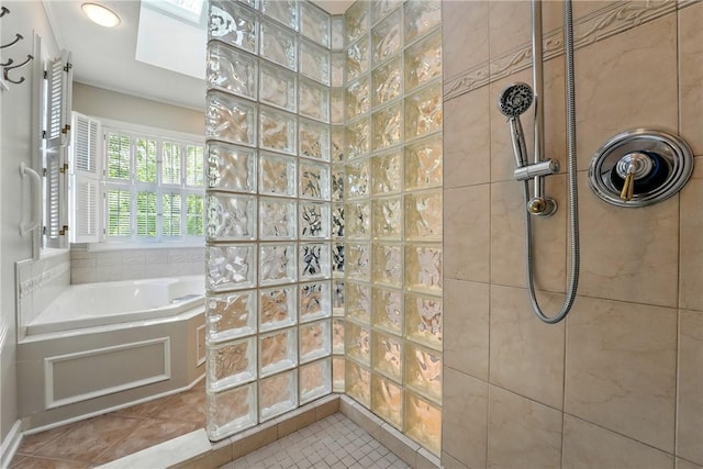 bathroom with a garden tub, walk in shower, tile patterned floors, and a skylight