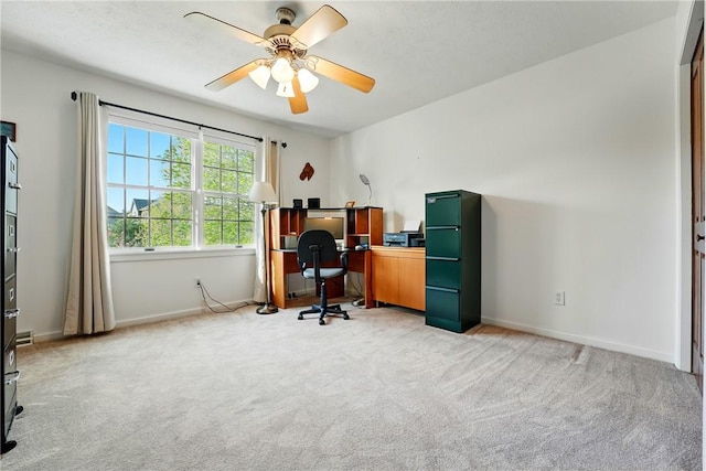 office area with ceiling fan, light colored carpet, and baseboards