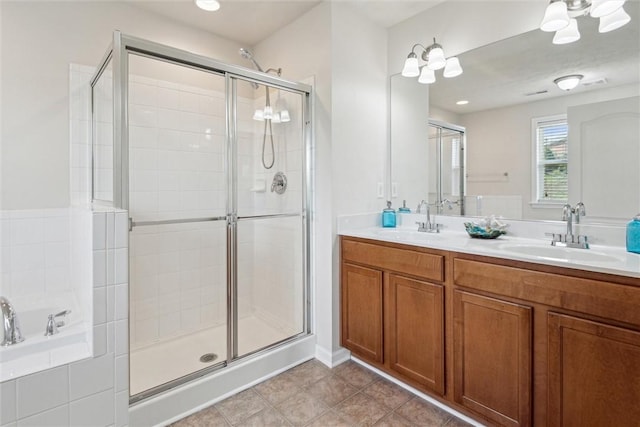 full bathroom with tile patterned flooring, a sink, double vanity, and a shower stall