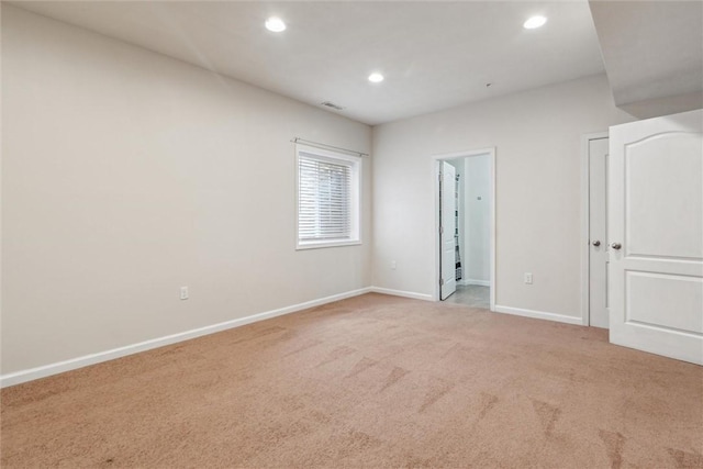 empty room with baseboards, carpet, recessed lighting, and visible vents