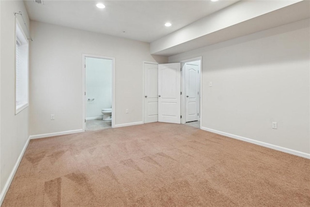 interior space with recessed lighting, carpet flooring, baseboards, and ensuite bath