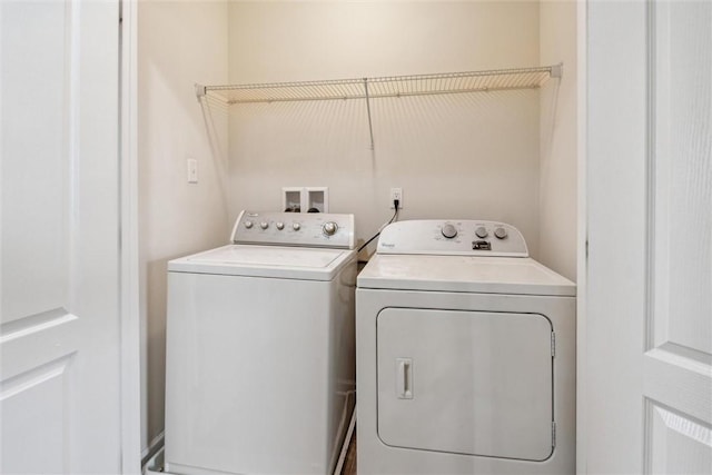 clothes washing area with independent washer and dryer and laundry area