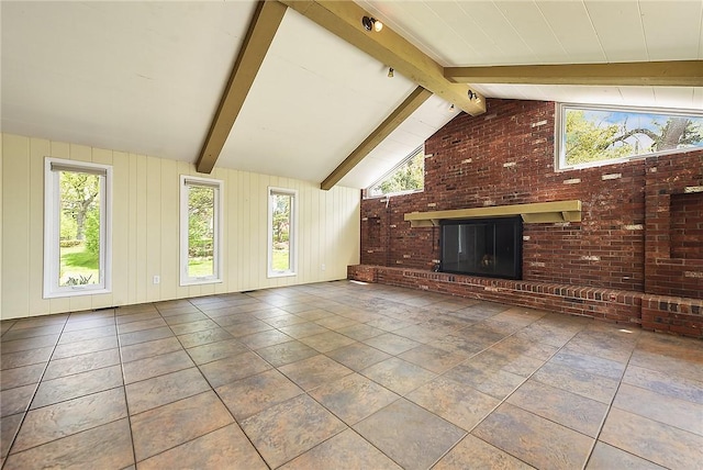 unfurnished living room with vaulted ceiling with beams and a fireplace