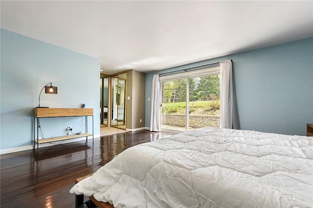 bedroom with baseboards, access to outside, and wood finished floors
