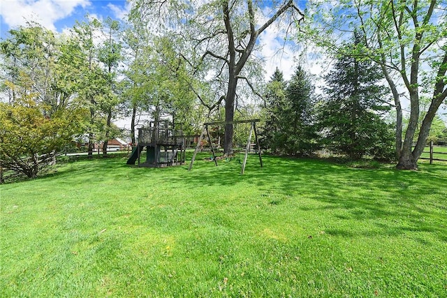 view of yard featuring a playground and fence