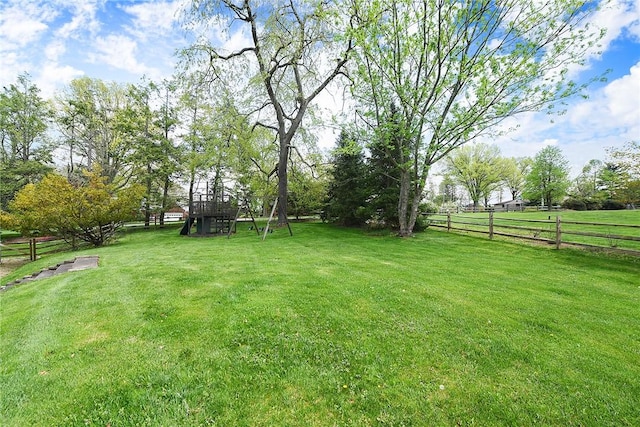 view of yard featuring fence and a playground